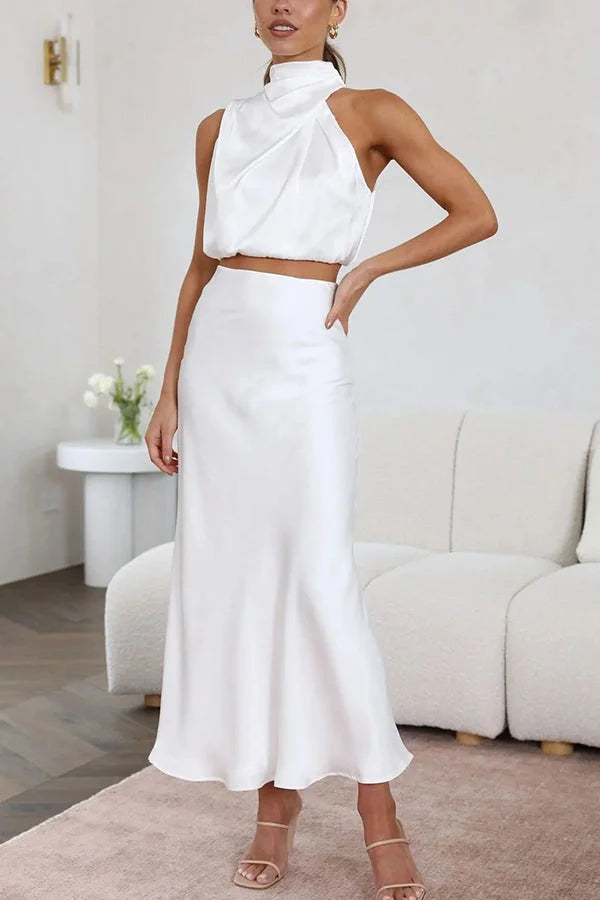 White satin skirt and top set featuring a flowing design.