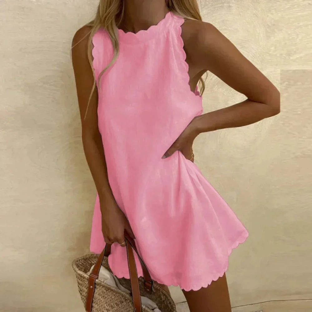Sleeveless dress in black with scalloped hem detail, made from lightweight cotton blend fabric perfect for summer days.