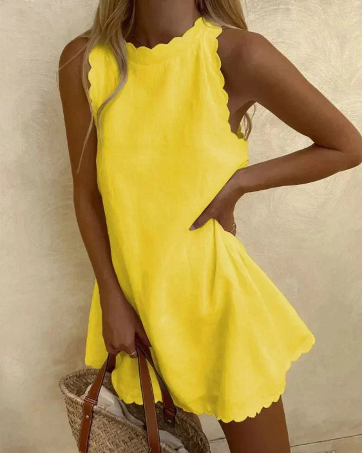 Sleeveless yellow dress with scalloped hem, crafted from lightweight and airy fabric, perfect for sunny days and outdoor…