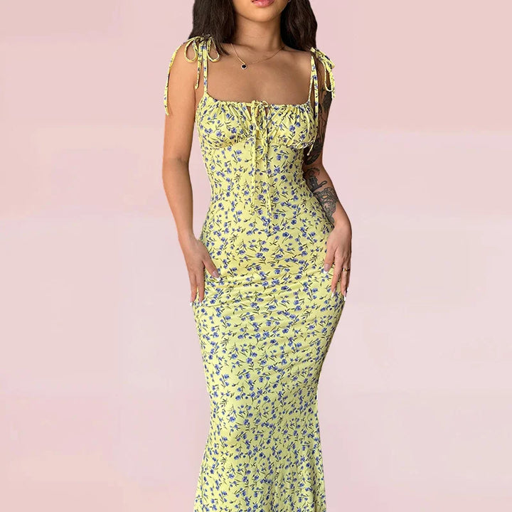 Yellow sleeveless floral maxi dress featuring a soft cotton blend fabric. Perfect for a sunny day out or casual gatherings.