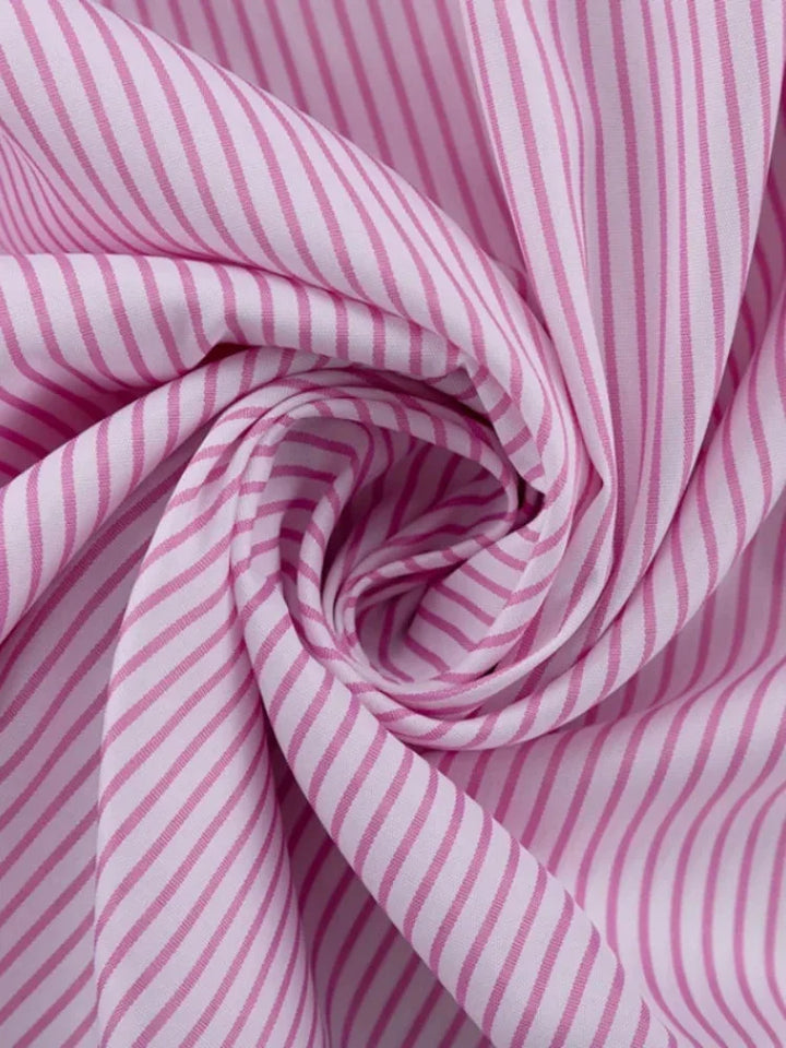 Striped pink dress with slit detail made from soft, lightweight fabric. Perfect for a chic and casual look.