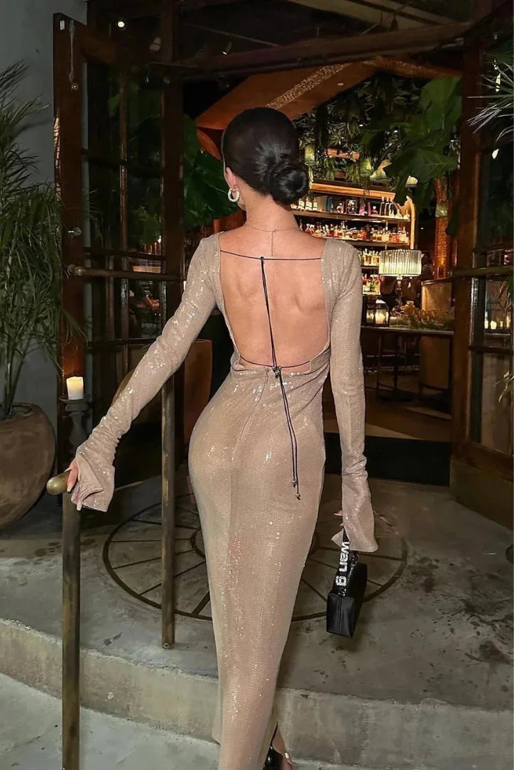 Beige sequined dress with long sleeves and deep V-neck. Elegant, sparkly design perfect for special occasions.