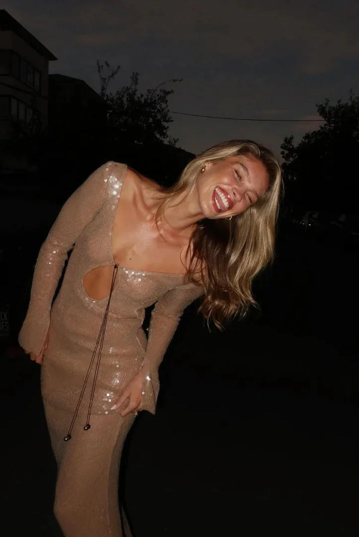 Beige sequined dress with long sleeves and deep V-neck, perfect for evening events or special occasions.