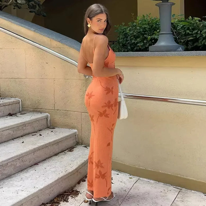 "Coral maxi dress featuring a chic floral pattern, perfect for a summer day out. Made of high-quality lightweight fabric."