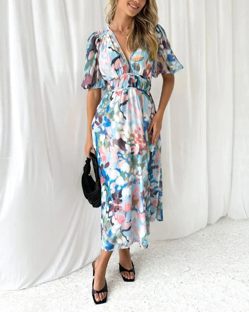 Floral maxi dress with long sleeves in lightweight cotton blend, featuring intricate floral patterns and a flowy silhouette.