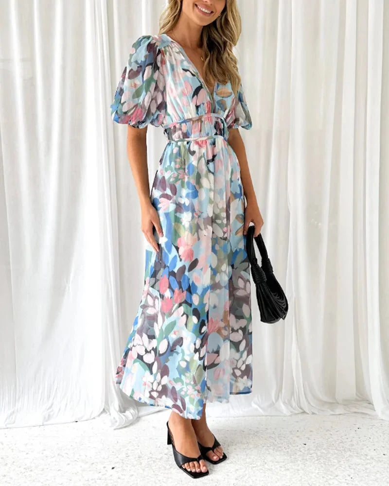 Floral maxi dress with long sleeves in a soft, flowy fabric, featuring a vibrant floral print perfect for any occasion.