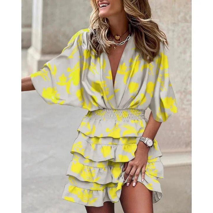 Yellow tiered abstract mini dress with a vibrant design, perfect for summer, made from high-quality lightweight fabric.