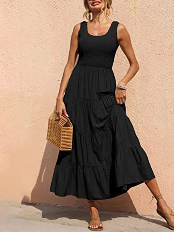 Black sleeveless maxi dress with smocked bodice. Features a comfortable stretch fabric and a flattering silhouette.