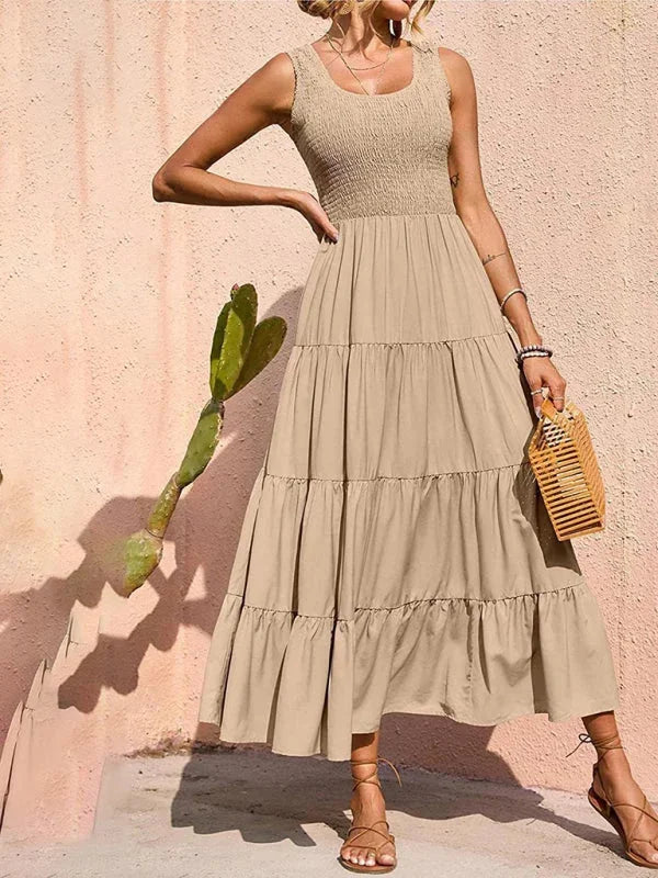 Khaki sleeveless maxi dress with smocked bodice, ideal for everyday wear or casual occasions.