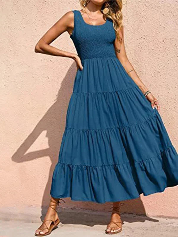 Peacock blue sleeveless maxi dress with smocked bodice, perfect for summer outings. Made from lightweight and breathable…