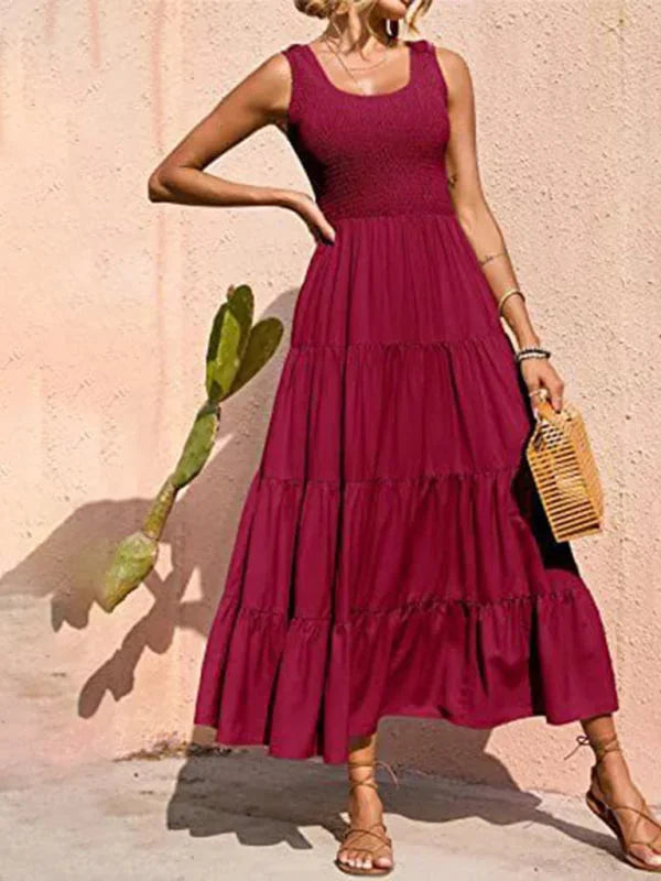 Red sleeveless maxi dress with smocked bodice, designed with a flowy silhouette in a soft, comfortable fabric.