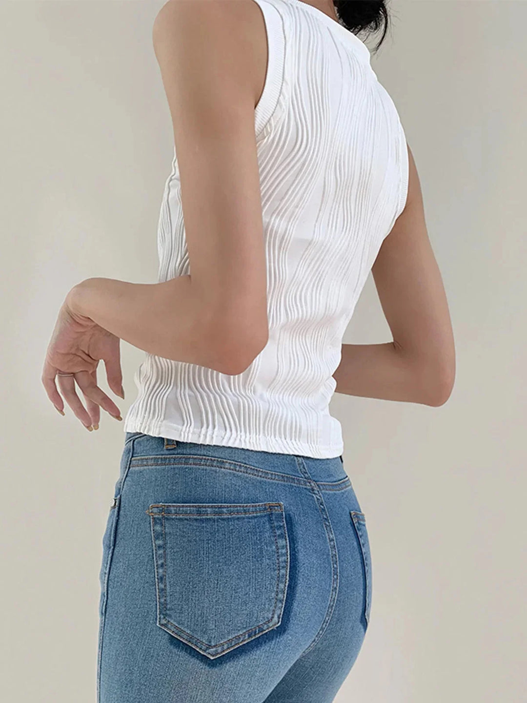 Sleeveless ribbed top in Shira featuring a smooth, fitted silhouette and a collarless design, ideal for effortlessly chic…
