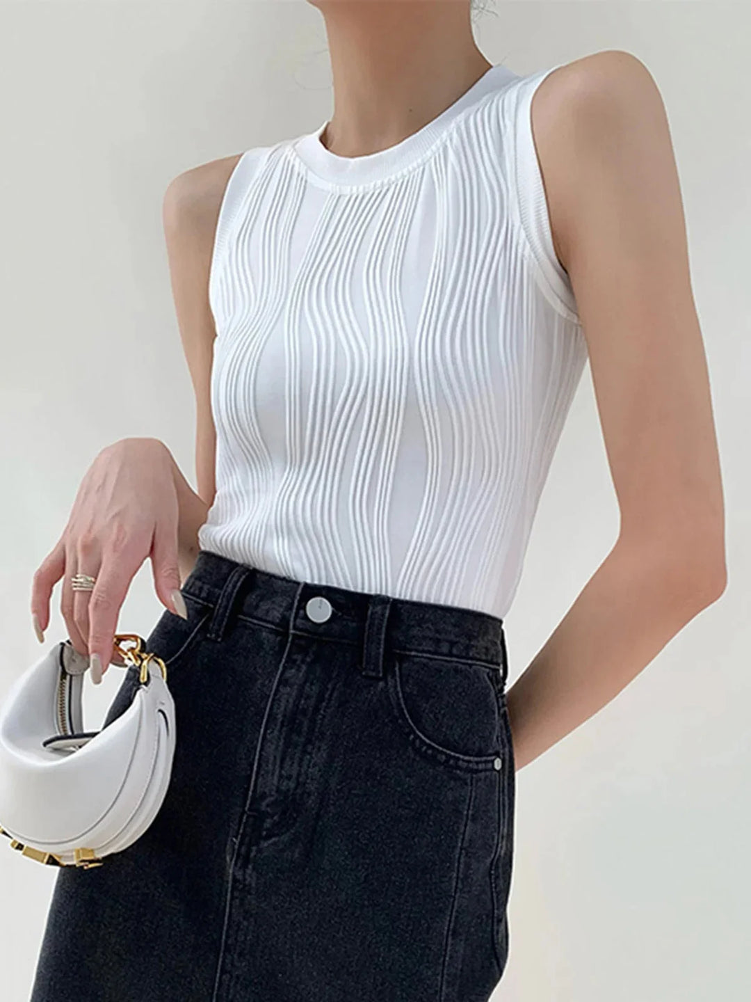 White ribbed sleeveless top, Shira brand. Sleek and modern design, perfect for layering. Made with soft and comfortable…