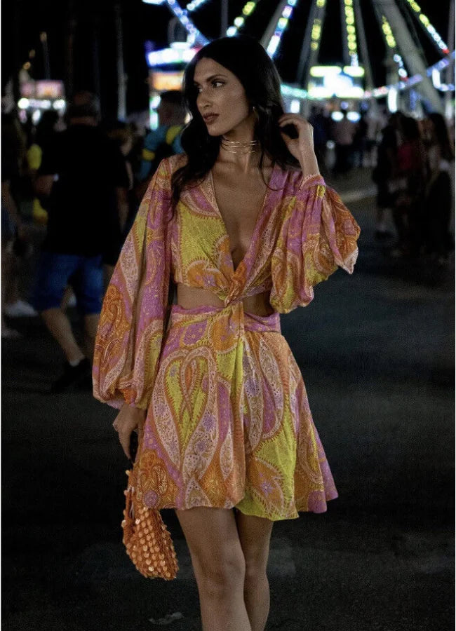 Pink and yellow patterned mini dress with V-neck, perfect for a playful summer look.