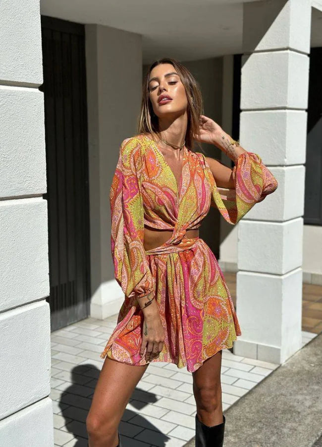 Pink and yellow patterned mini dress with V-neck made of breathable fabric, perfect for casual outings or summer events.