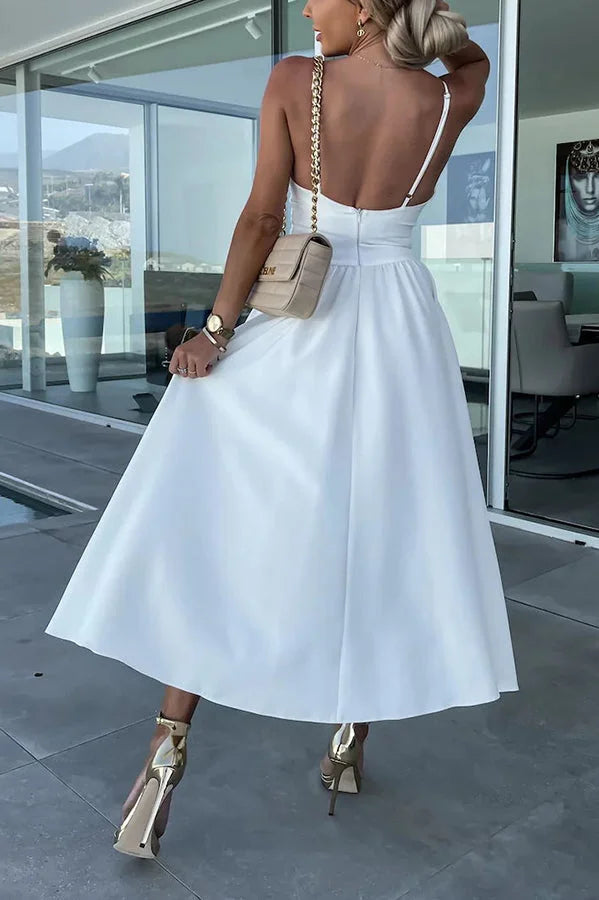 Siana dress featuring cut-out detail, pockets, and midi length in cotton blend fabric.