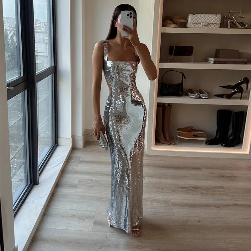 Silver sequined floor-length dress with a V-neck, cap sleeves, and a flowing silhouette.