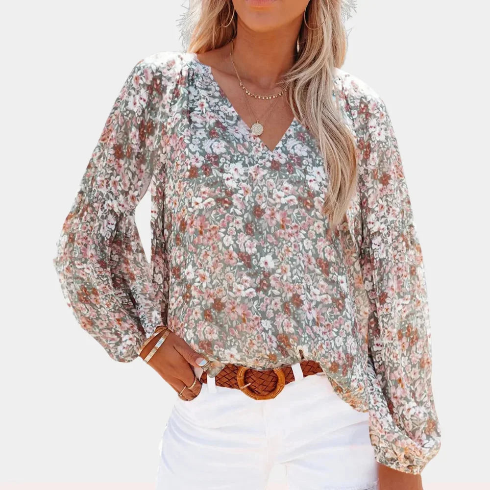 Multicolour Sima blouse with V-neck, bell sleeves & intricate pattern. Made of lightweight, breathable fabric.
