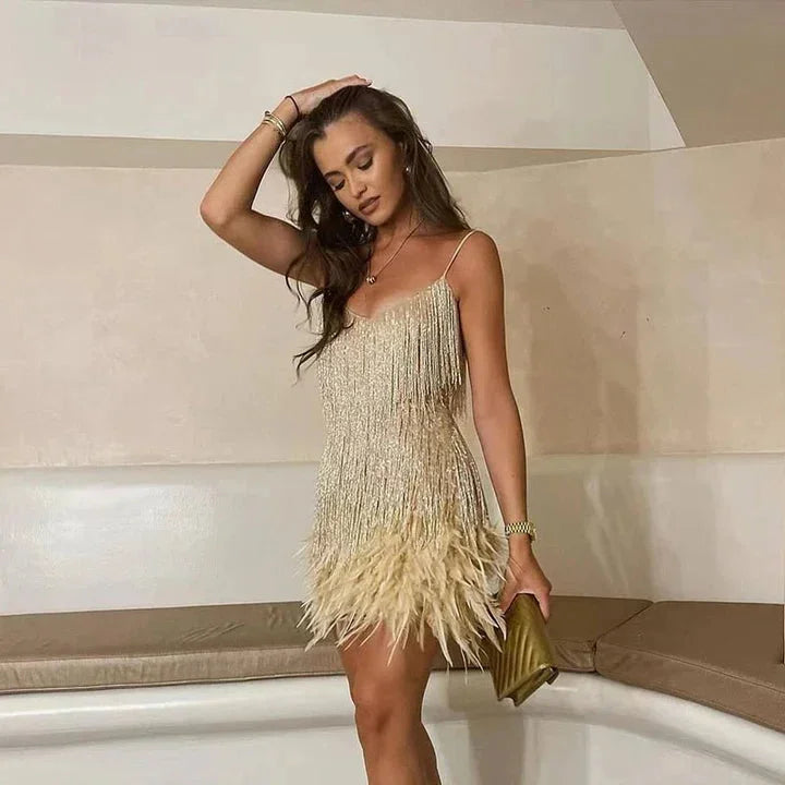 Gold fringe cocktail dress with a modern cut, perfect for a night out. Sparkling material adds flair to your look.