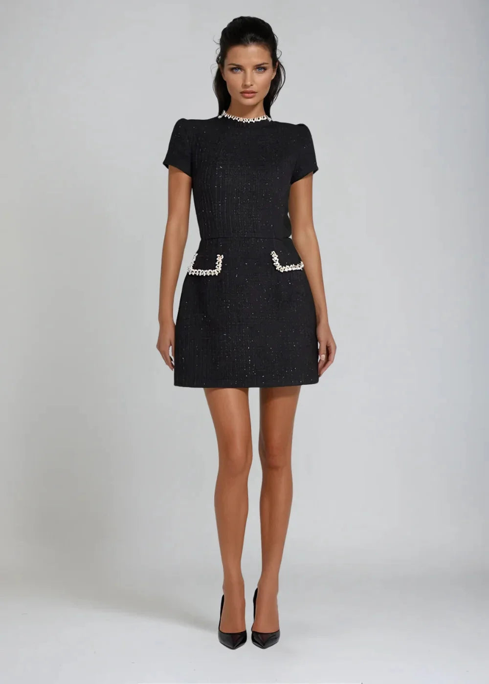 Skylynn mini dress features a mock neck design with intricate bead details, perfect for a chic and stylish look.