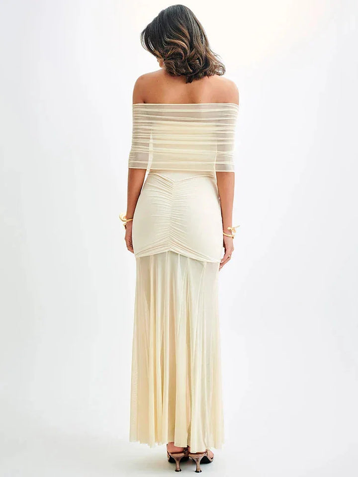 Off-shoulder ruched bodice maxi dress in soft cotton blend with floral print and flowing silhouette.