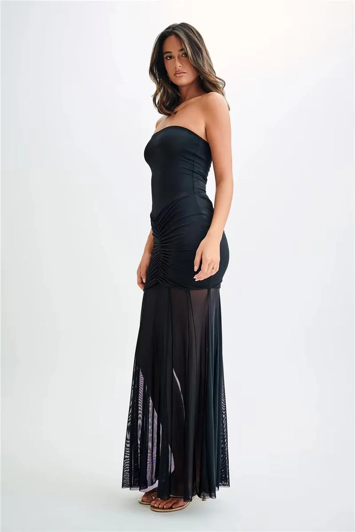 Off-shoulder navy blue maxi dress with ruched bodice. Made from soft, flowy fabric, featuring a classic design for any…