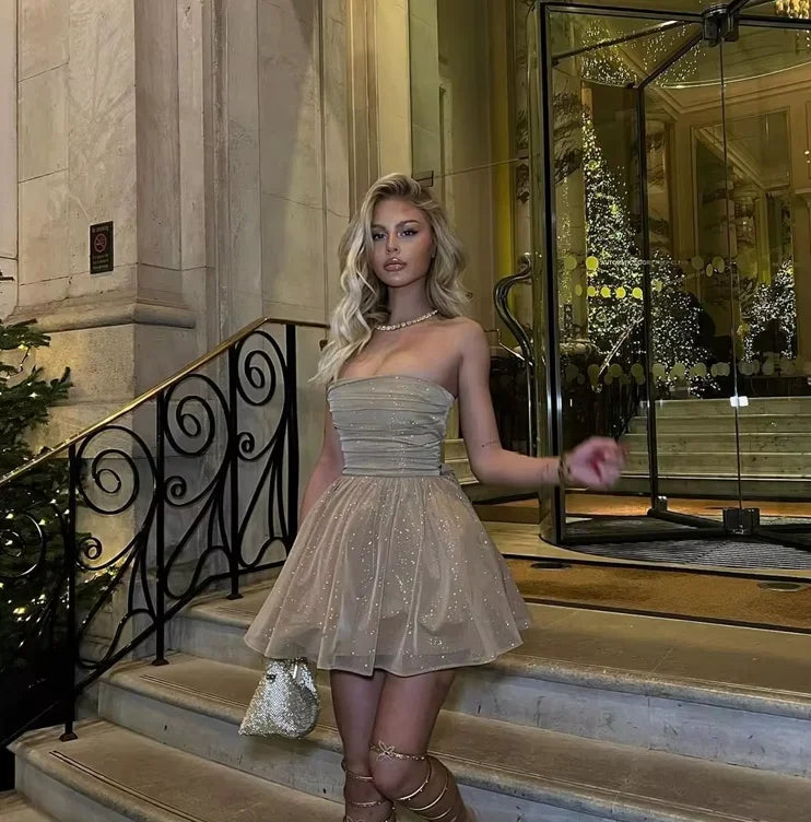 Shimmering mini dress with pleated design, perfect for special occasions, made of high-quality fabric.