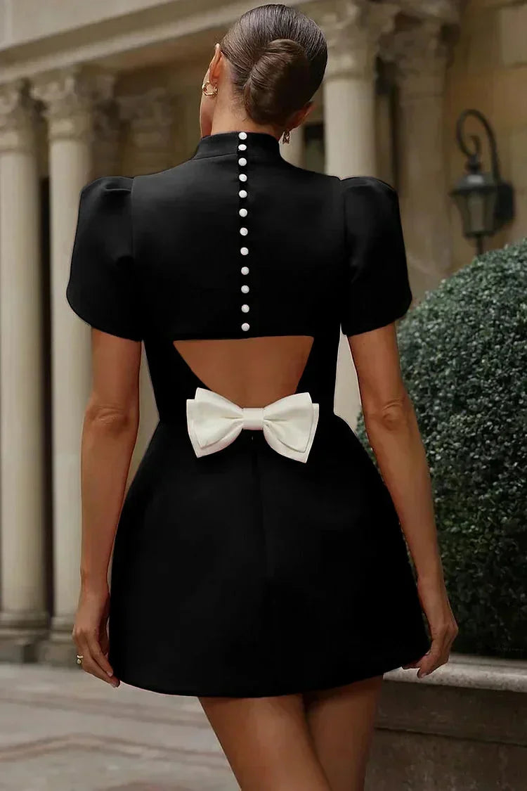 Navy blue mini dress with ruffle sleeves and V-neck design, perfect for formal events.