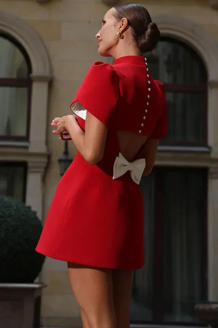 "Elegant mini dress in black with ruffle sleeves, perfect for formal occasions, made from soft and lightweight fabric."