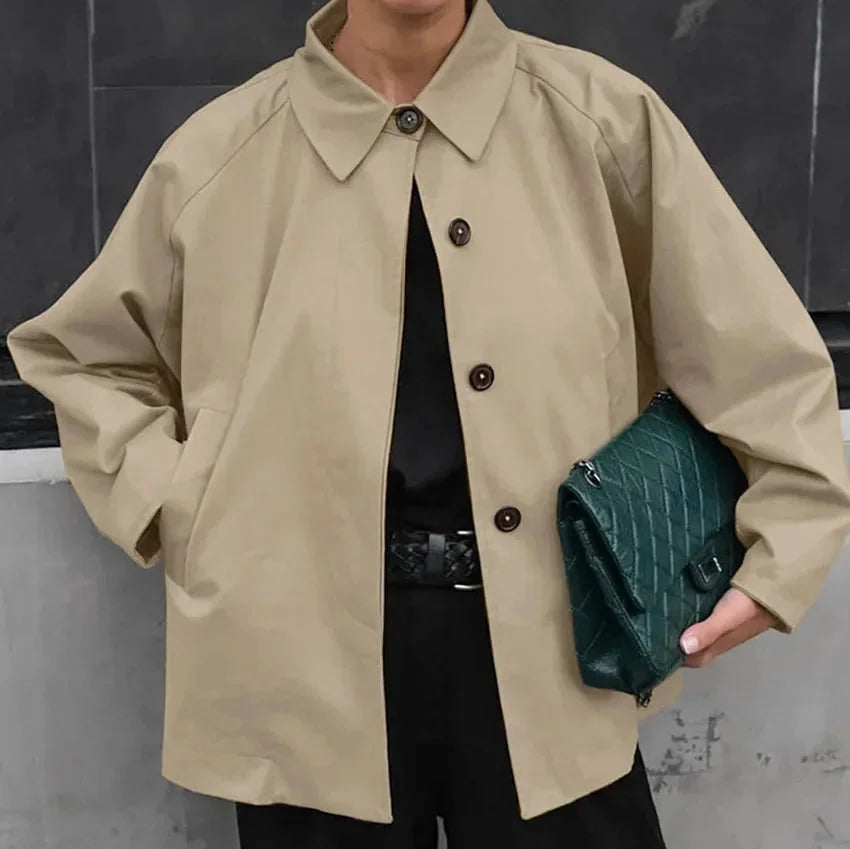 Oversized khaki trench coat with button-up front, made of soft and durable fabric for a stylish and comfortable look.