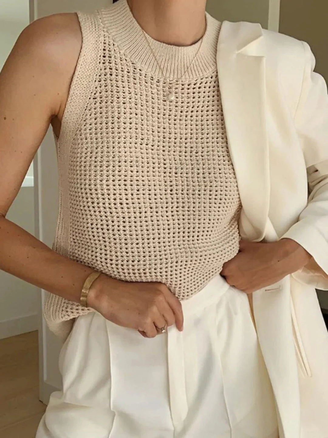 "Sleeveless knit top in Apricot, crafted from breathable fabric for comfort. Chic and versatile design ideal for everyday…