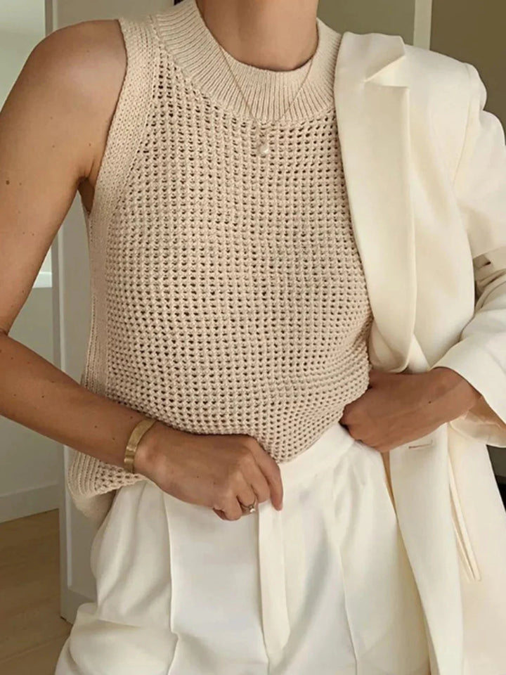 "Sleeveless knit top in Apricot, crafted from breathable fabric for comfort. Chic and versatile design ideal for everyday…