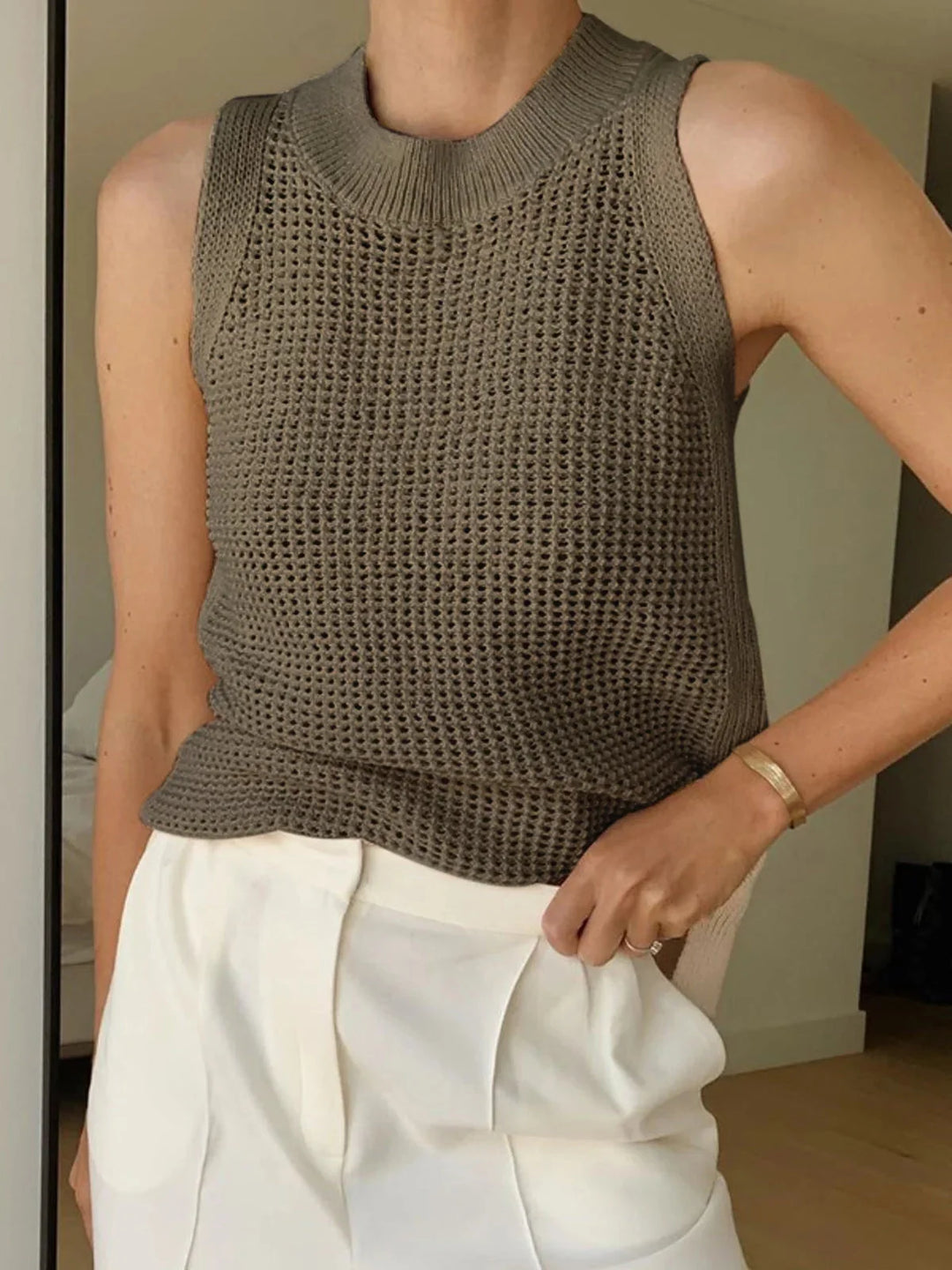 Dark brown sleeveless knit top in breathable fabric with a textured design.