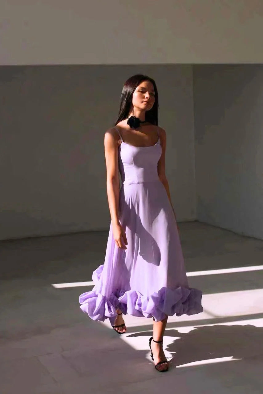 "Sylvie sleeveless dress in white with tiered ruffle hem, perfect for spring events."