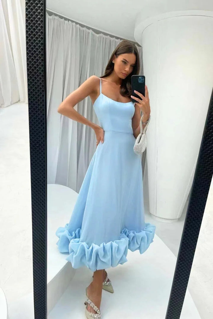 Blue sleeveless dress with ruffled hemline, perfect for summer events. Made of lightweight fabric with a unique asymmetrical…