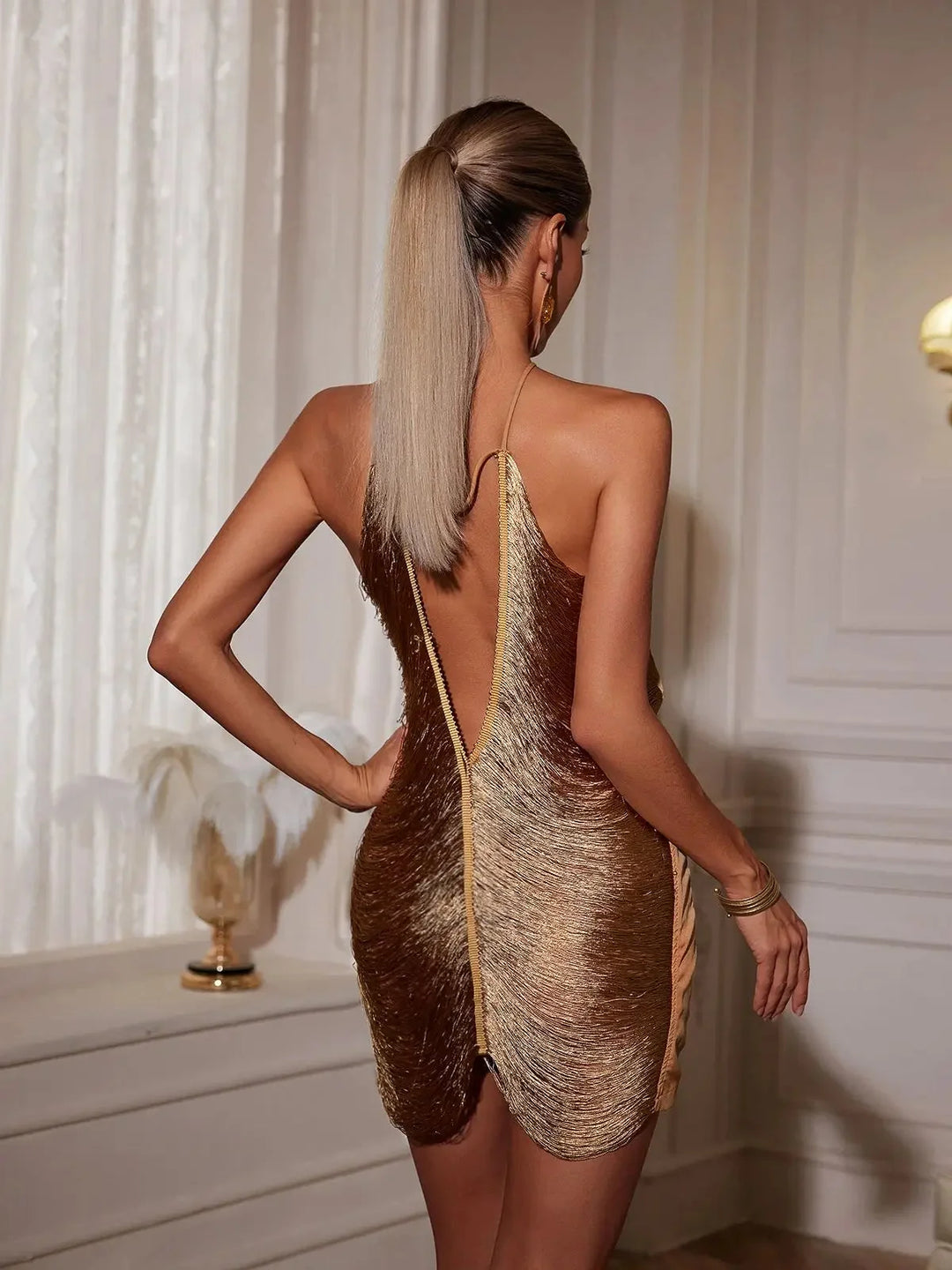 Asymmetric zip metallic dress in shimmering silver material with unique design detail.