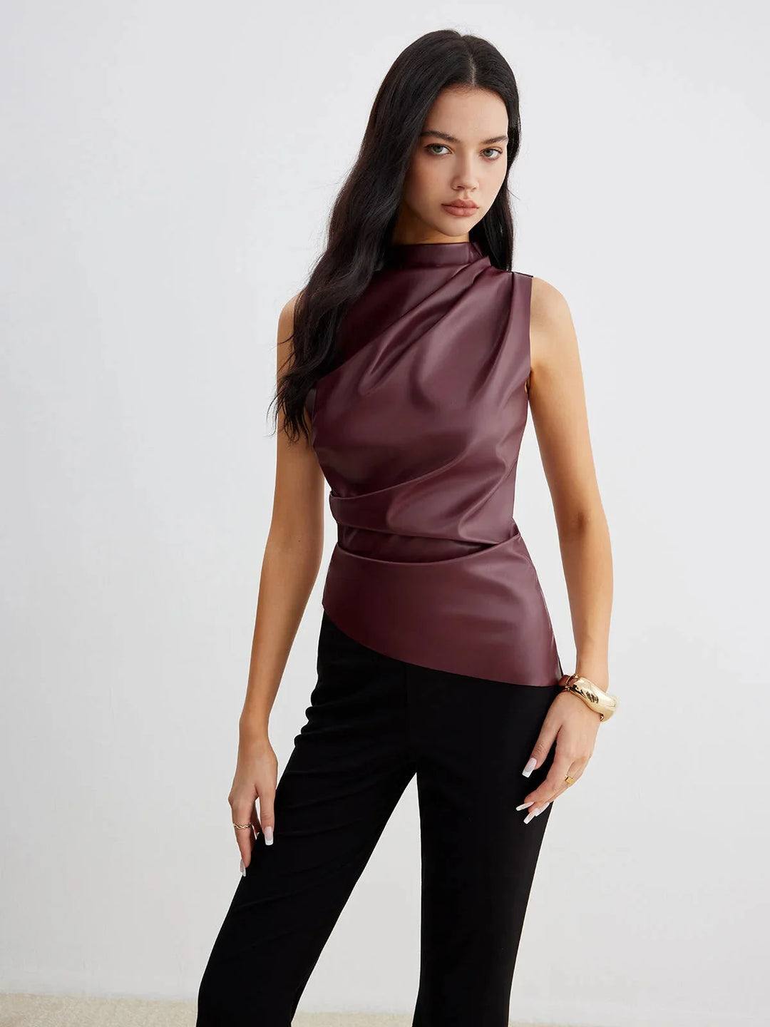 Sleeveless satin top with gathered neckline in a smooth and polished fabric, perfect for dressing up any outfit.