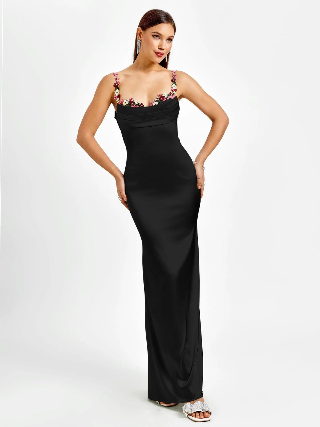 "Sleeveless black maxi dress with intricate embellishments, showcasing a fitted silhouette and elegant design by Tara."
