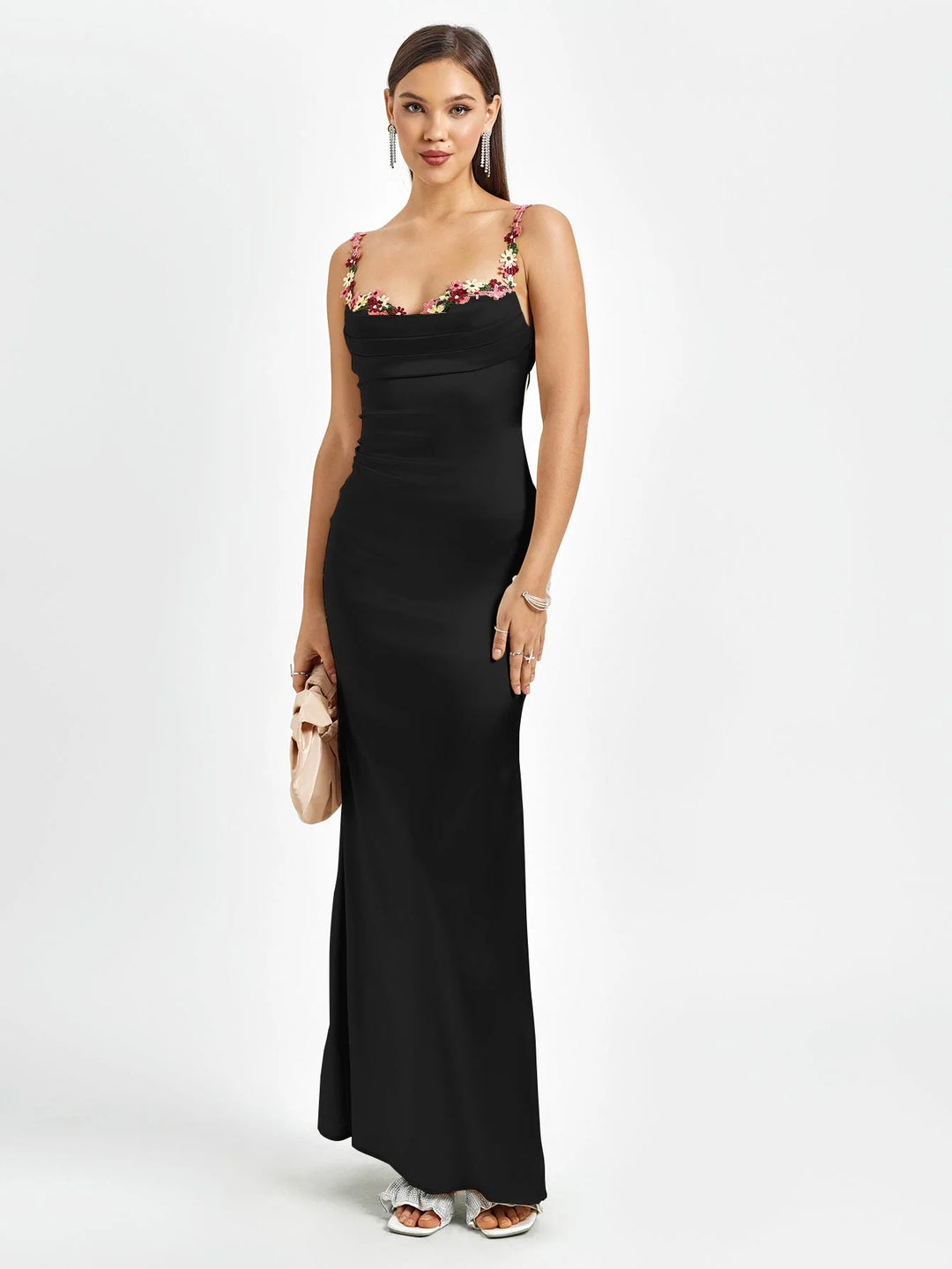 Black sleeveless maxi dress with intricate embellishments. Fitted design made with high-quality fabric.