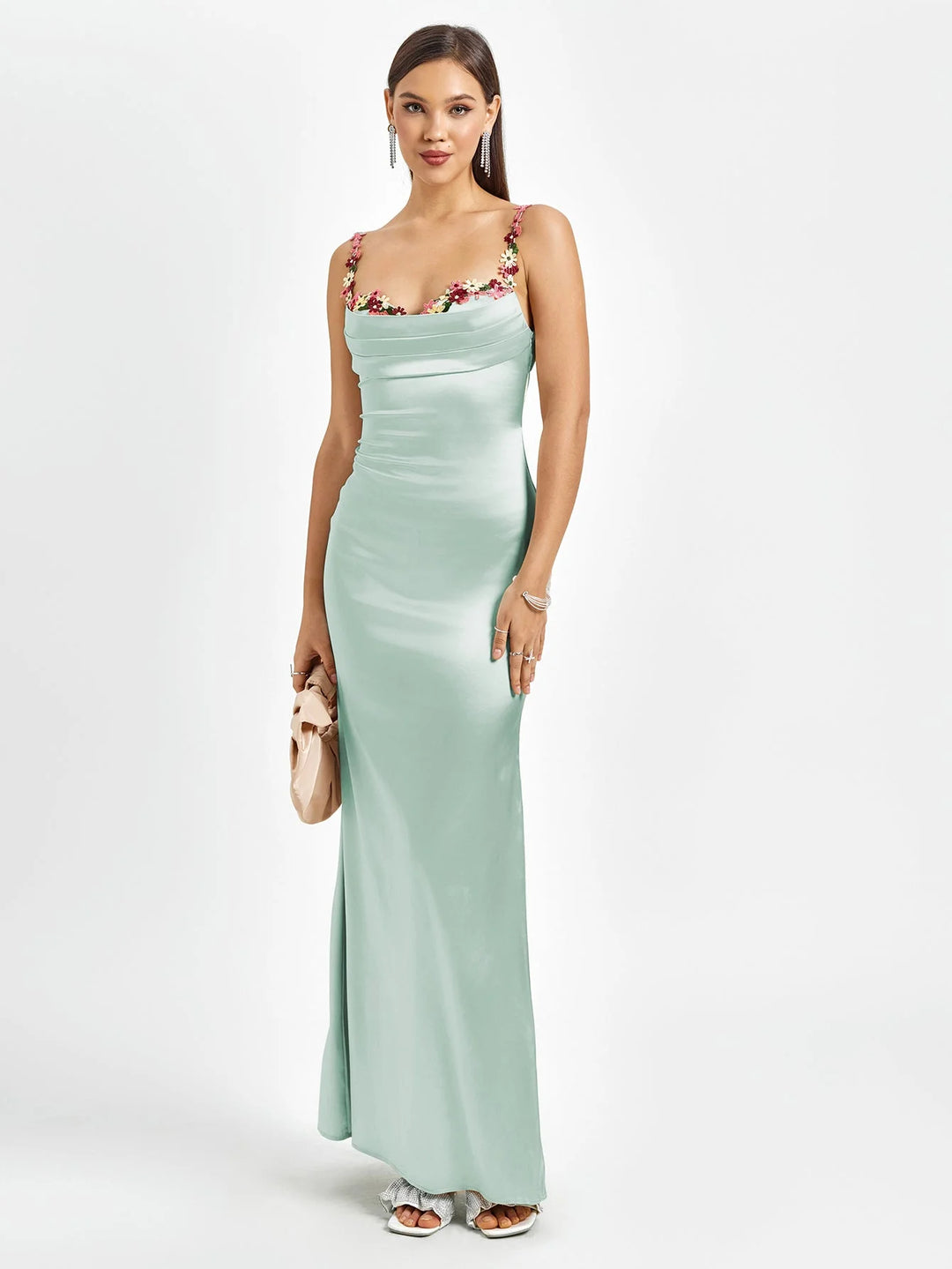 "Mint green sleeveless maxi dress with embellishments in a fitted style, perfect for a chic and elegant look."