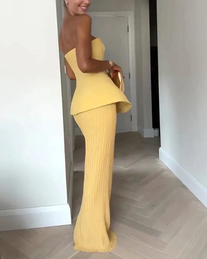 Yellow strapless peplum top with ribbed skirt in a soft and stretchy material, perfect for casual outings or daytime events.