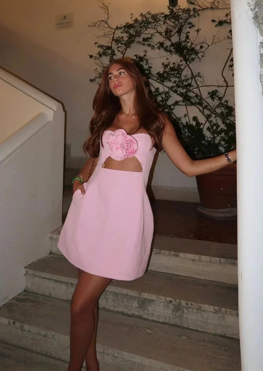 Floral mini dress showcasing cutout detail on the waist, made of lightweight cotton blend, perfect for a chic daytime look.