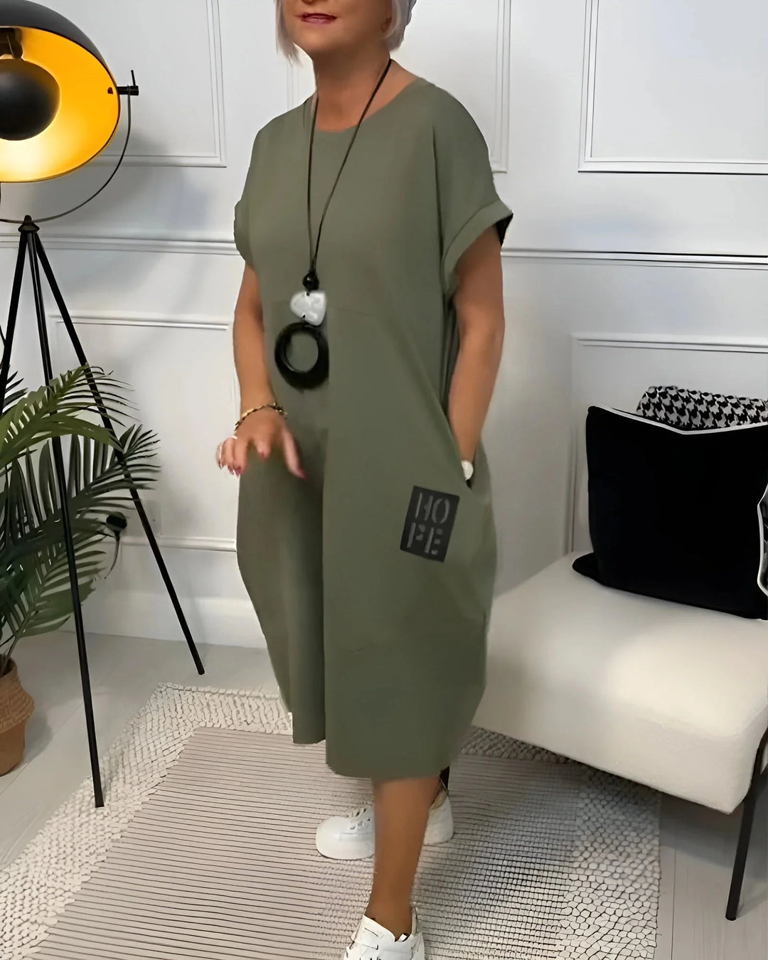 "Black sleeveless midi dress with pleated detailing and stretchy fabric for a comfortable yet chic look by Taya"