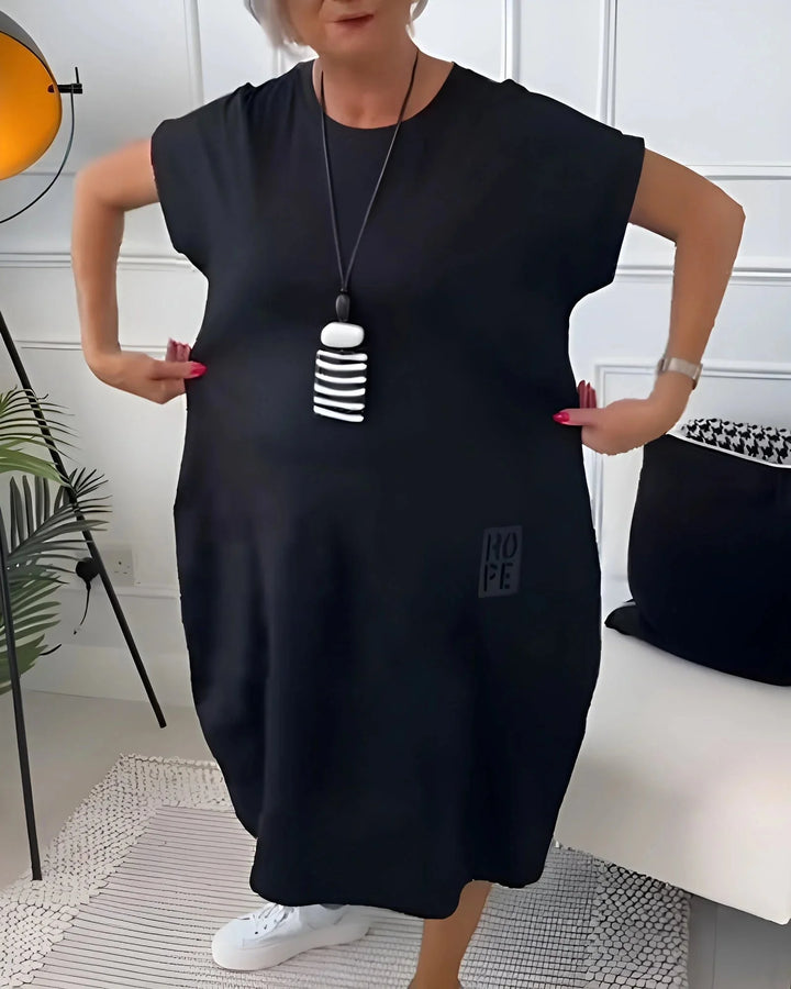 "Gray knee-length dress with cowl neckline, three-quarter sleeves, and A-line silhouette for a chic and relaxed look."