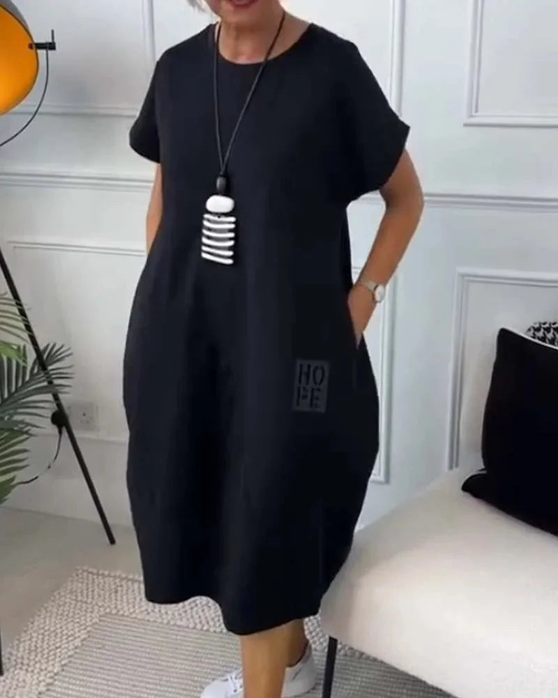 "Black midi dress made of soft, stretchy fabric with a flattering fit and chic design."