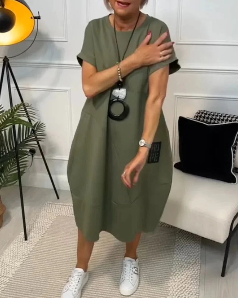 "Black cotton midi dress with a relaxed fit and trendy design, perfect for everyday wear."