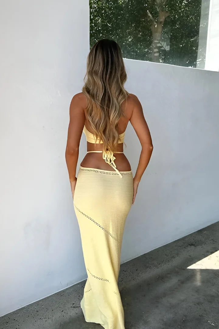 Yellow halterneck midi dress with cut-outs, made from lightweight fabric. Features a figure-flattering design for a chic…