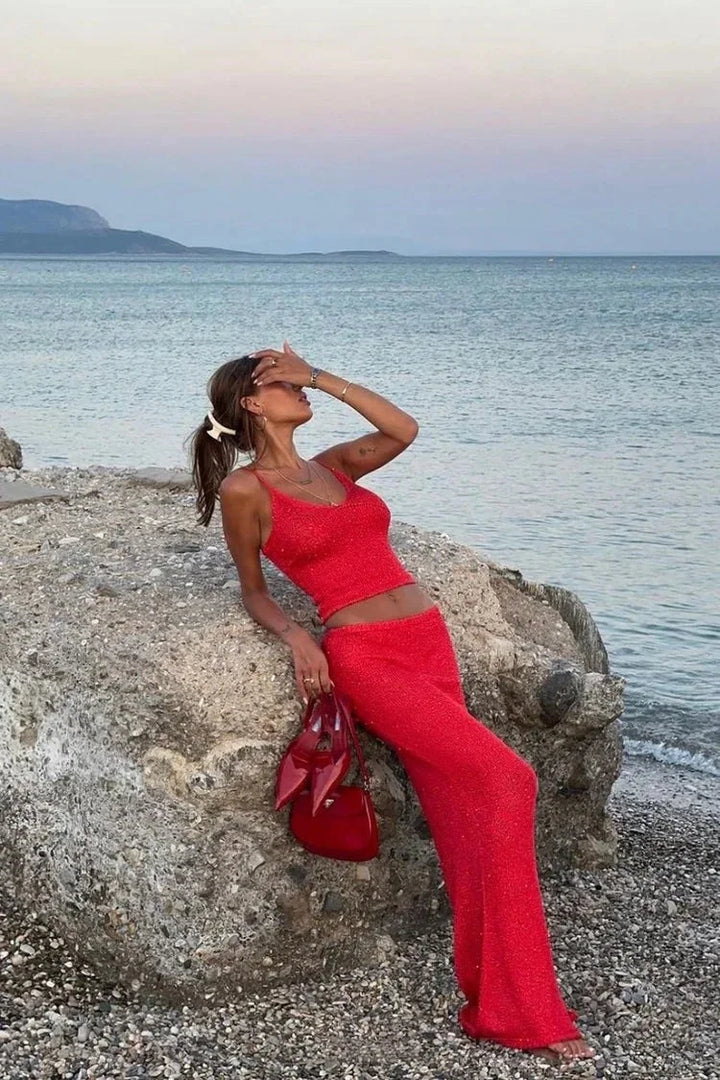 Red sparkly top and pants set, made with shimmering fabric. Perfect for festive occasions and adding a touch of glamour to…