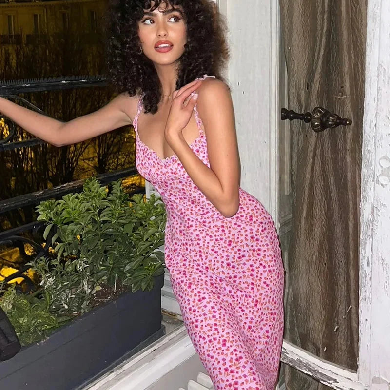 Pink floral print midi dress featuring a vibrant flower design on light, flowy fabric with a flattering midi length and…