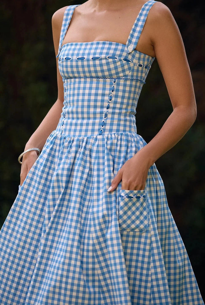 Off-shoulder midi dress in summery blue showcasing a delicate floral print. Perfect for warm-weather occasions.